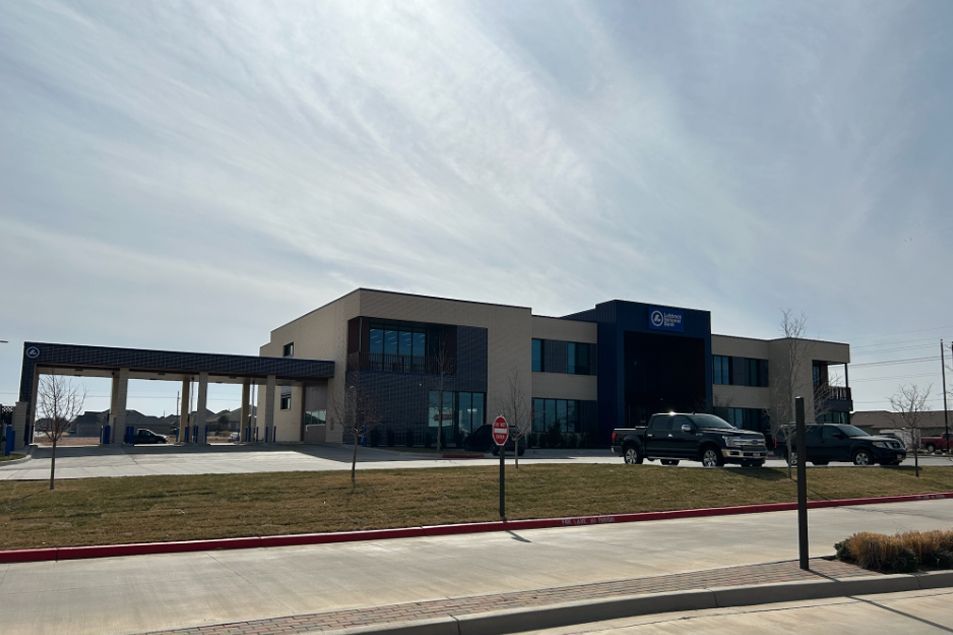 A large building with cars parked in front of it.