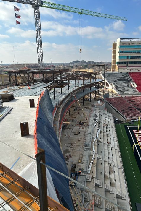 A stadium under construction with a crane in the background