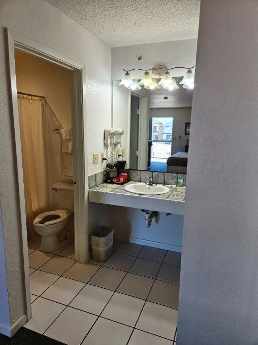 Bathroom with a sink, mirror, and toilet