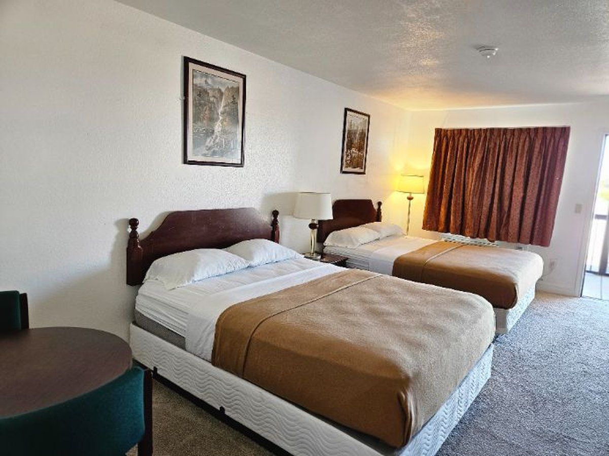 Motel room with two double beds