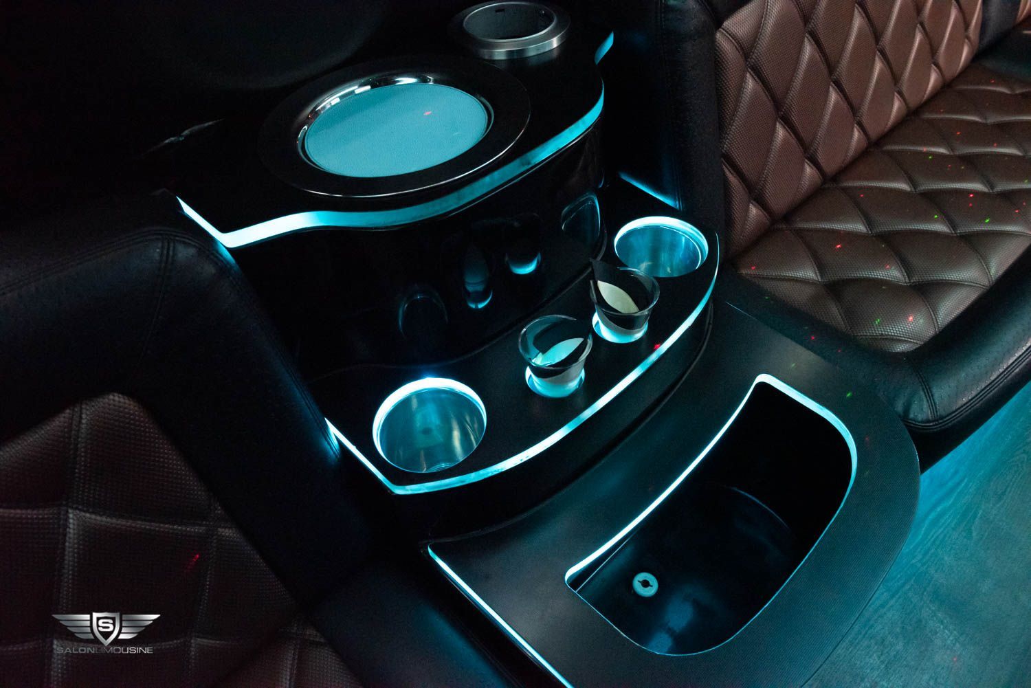 A close up of a car console with a blue light on it