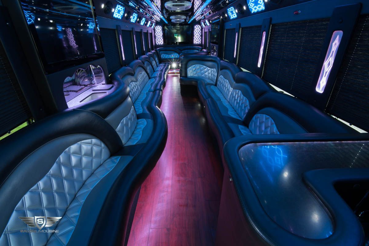 The inside of a limousine with a lot of seats and lights.