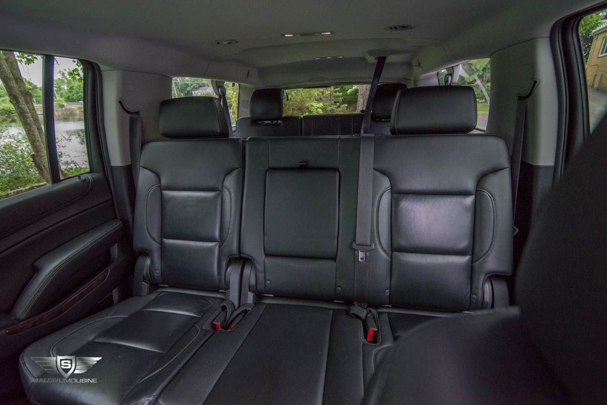 The back seat of a chevrolet suburban suv with three seats.