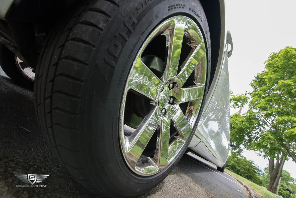 A close up of a car wheel with a chrome rim