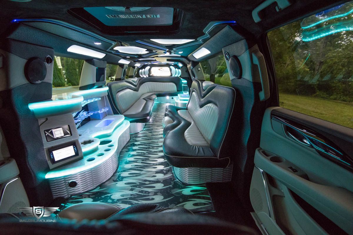 The inside of a limousine with a lot of seats and lights.