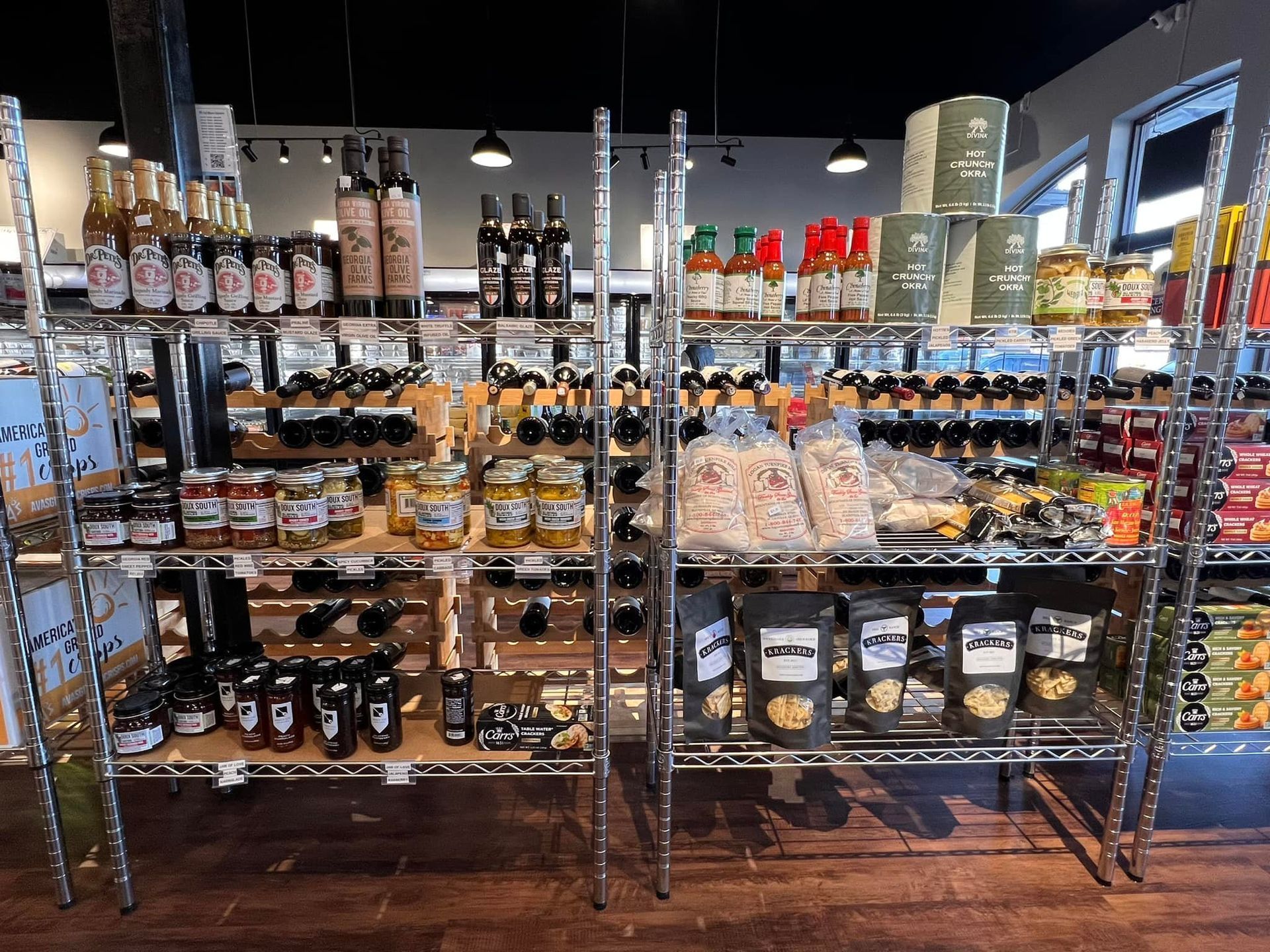Shelves stocked with various jars, bottles, and bags of gourmet food items in a store.