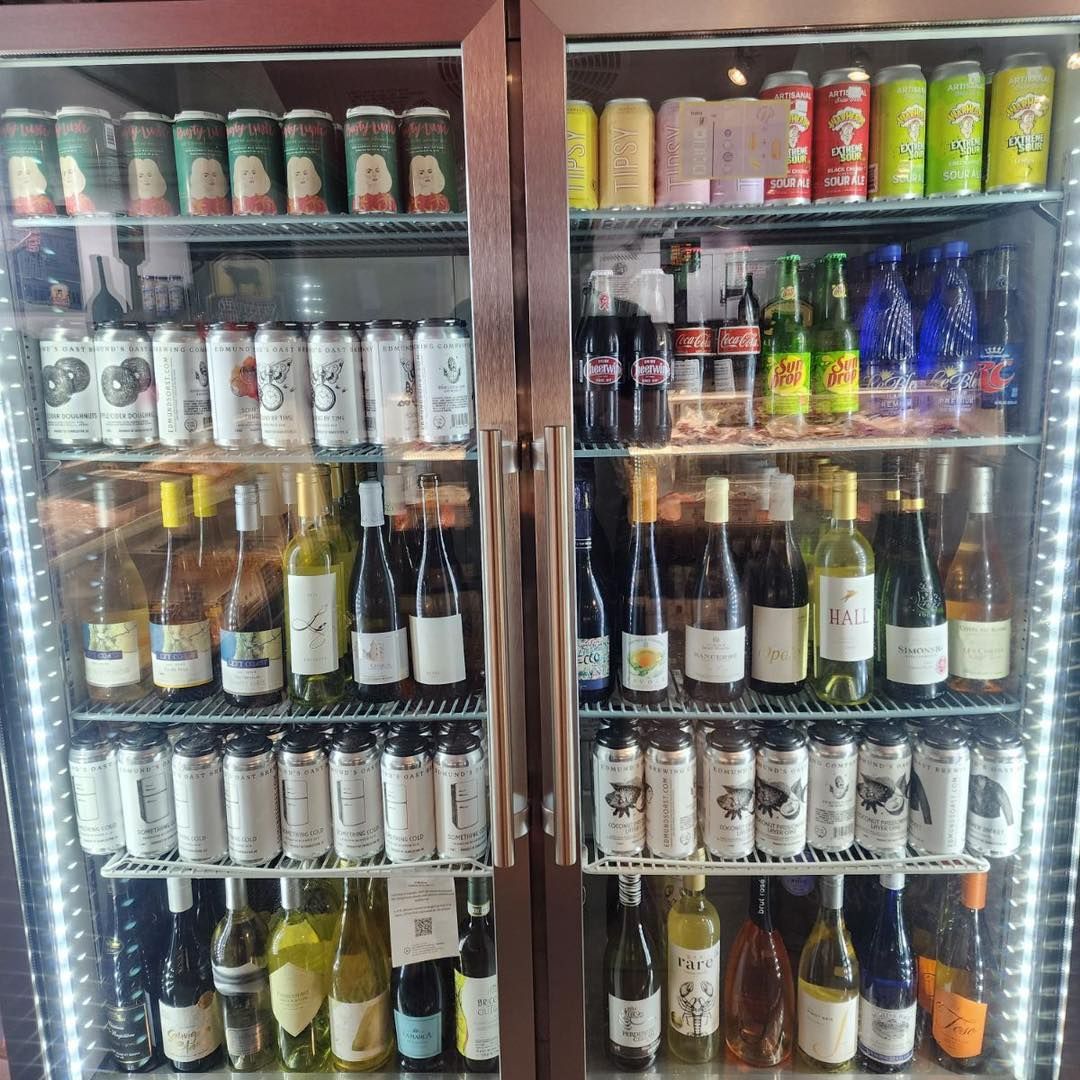 Two refrigerated glass door beverage coolers filled with various canned and bottled drinks.