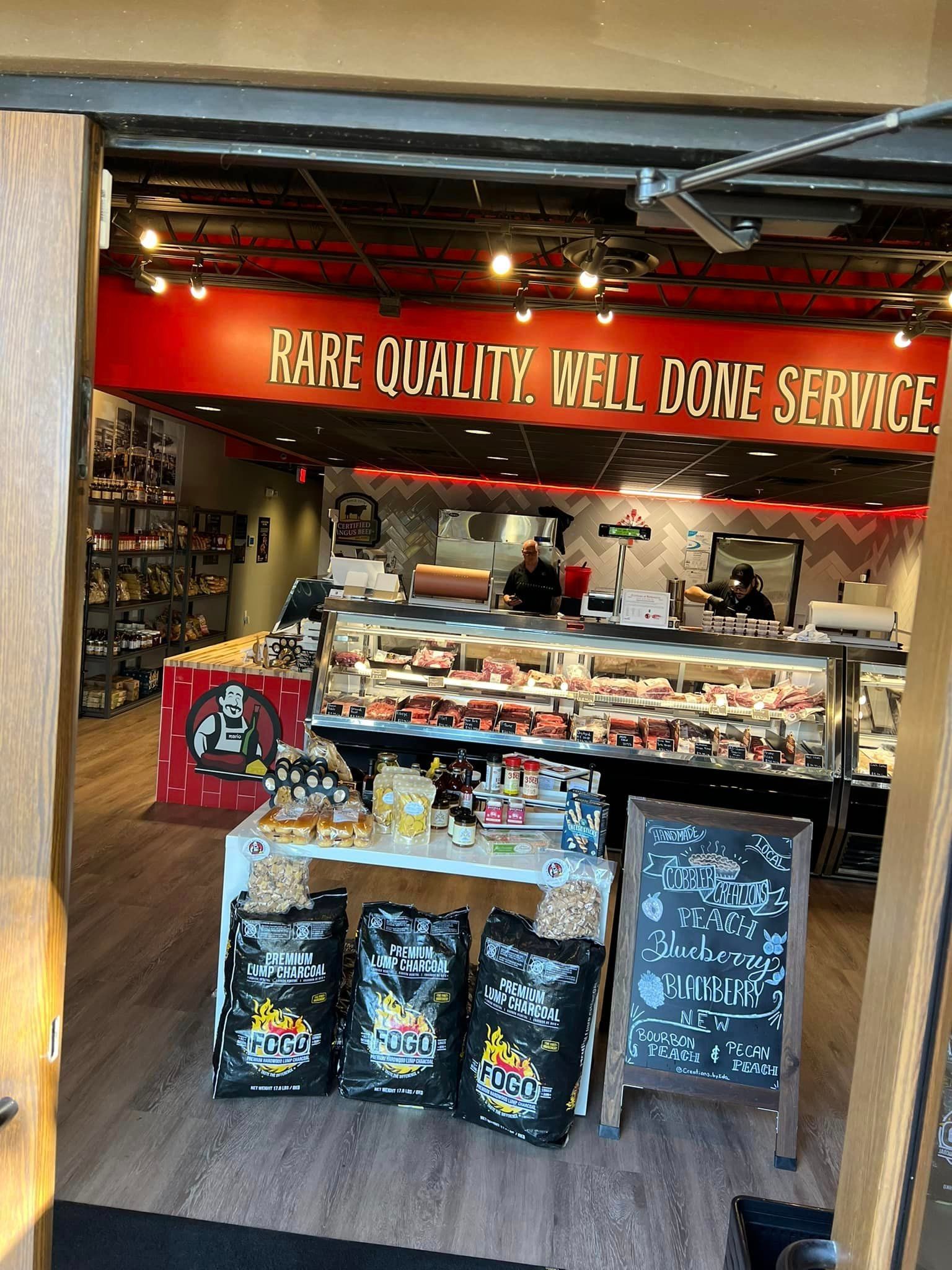 Butcher shop interior with meat display case, sign reading