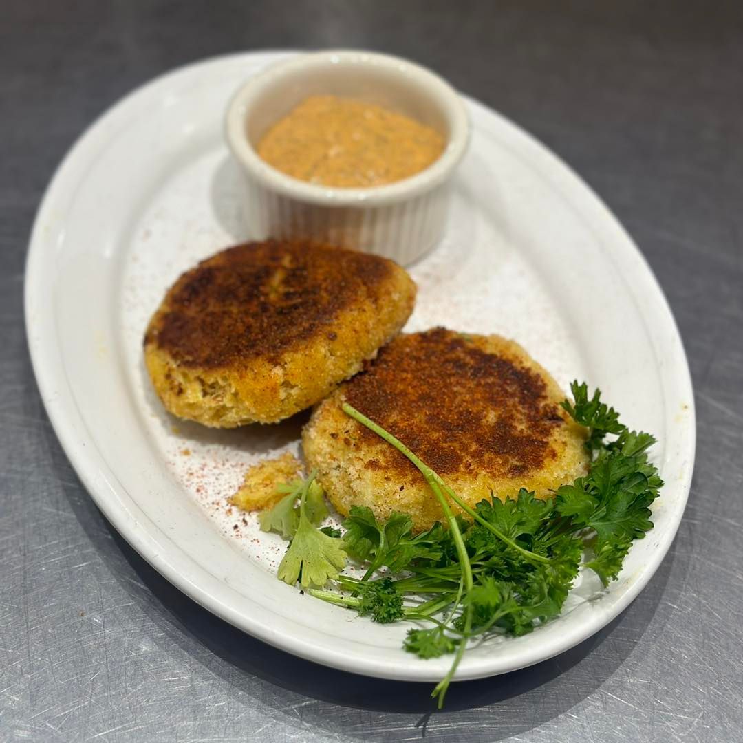 Two cooked crab cakes
