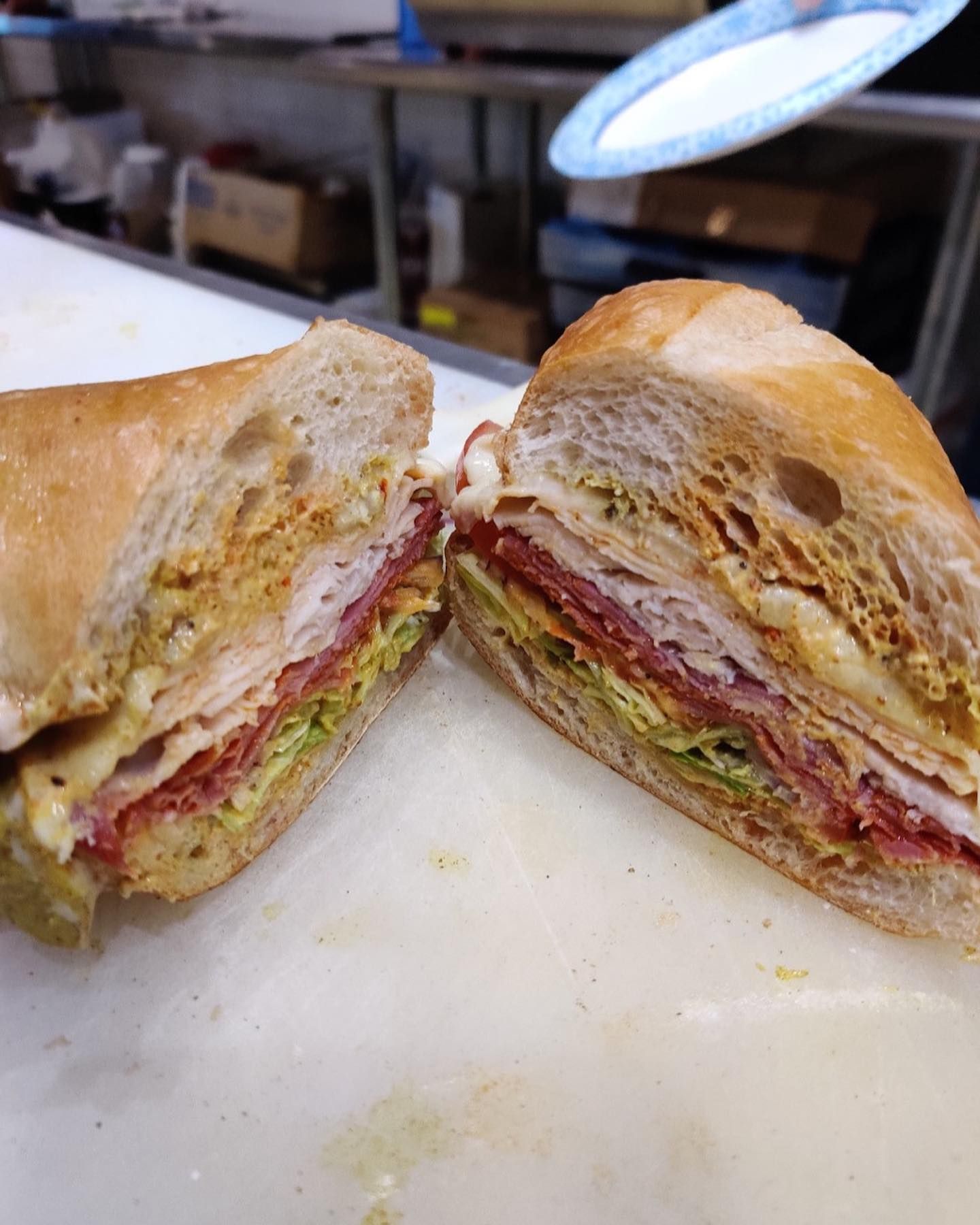 A split sandwich on a white surface