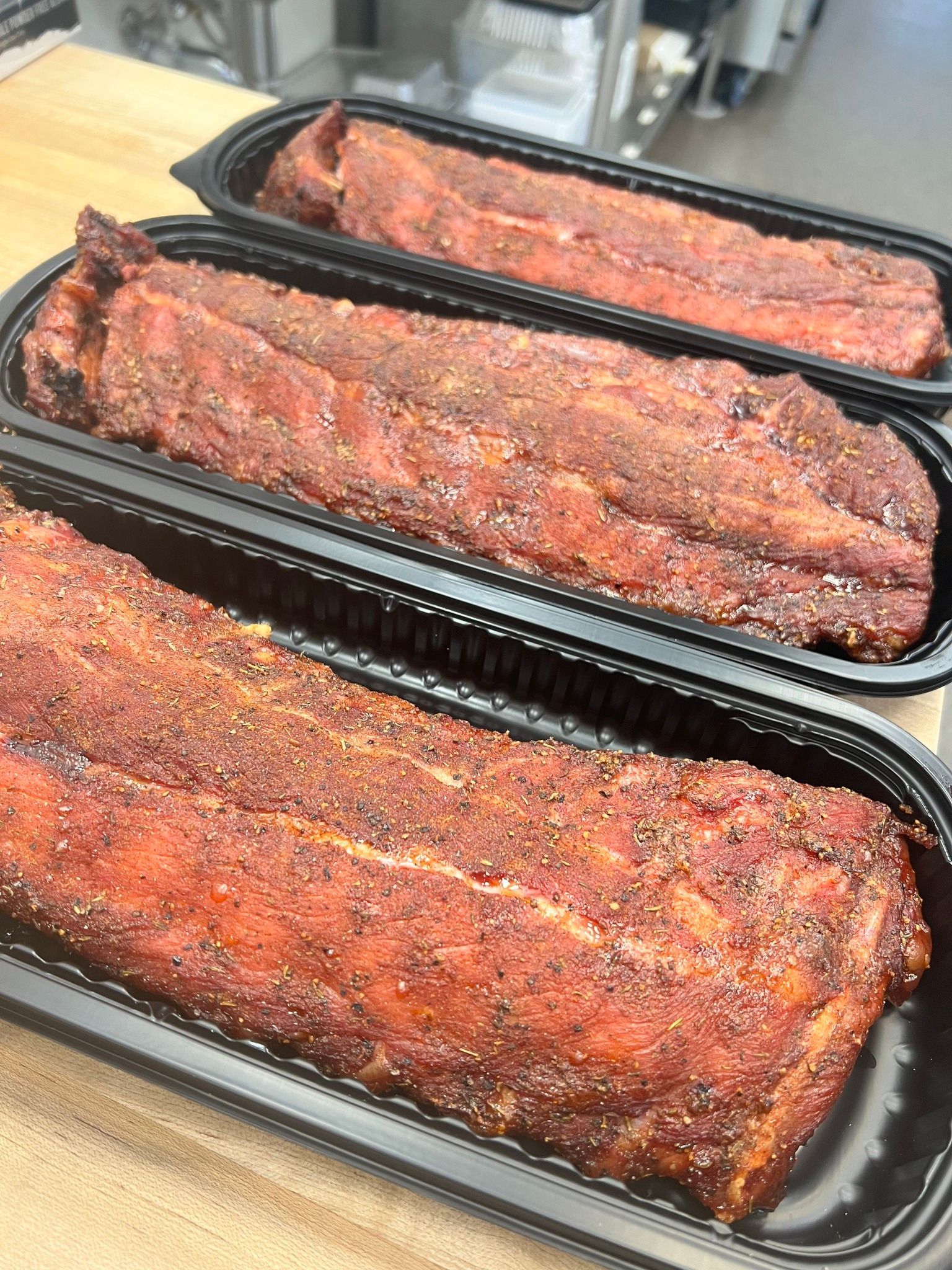 Smoked ribs  in black containers