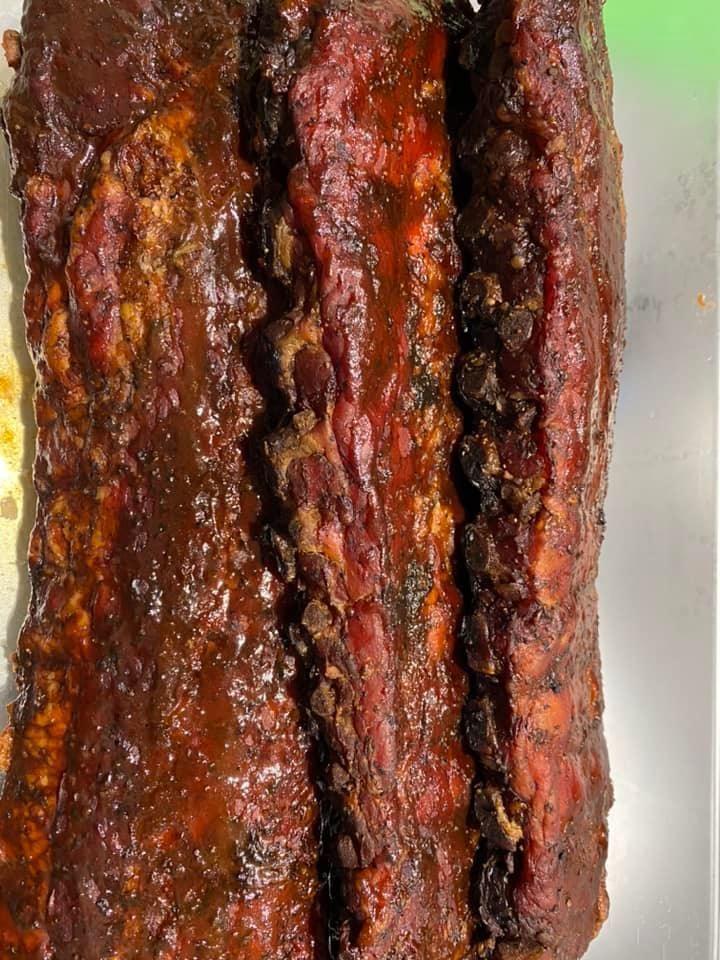 Smoked ribs with a dark, glossy glaze