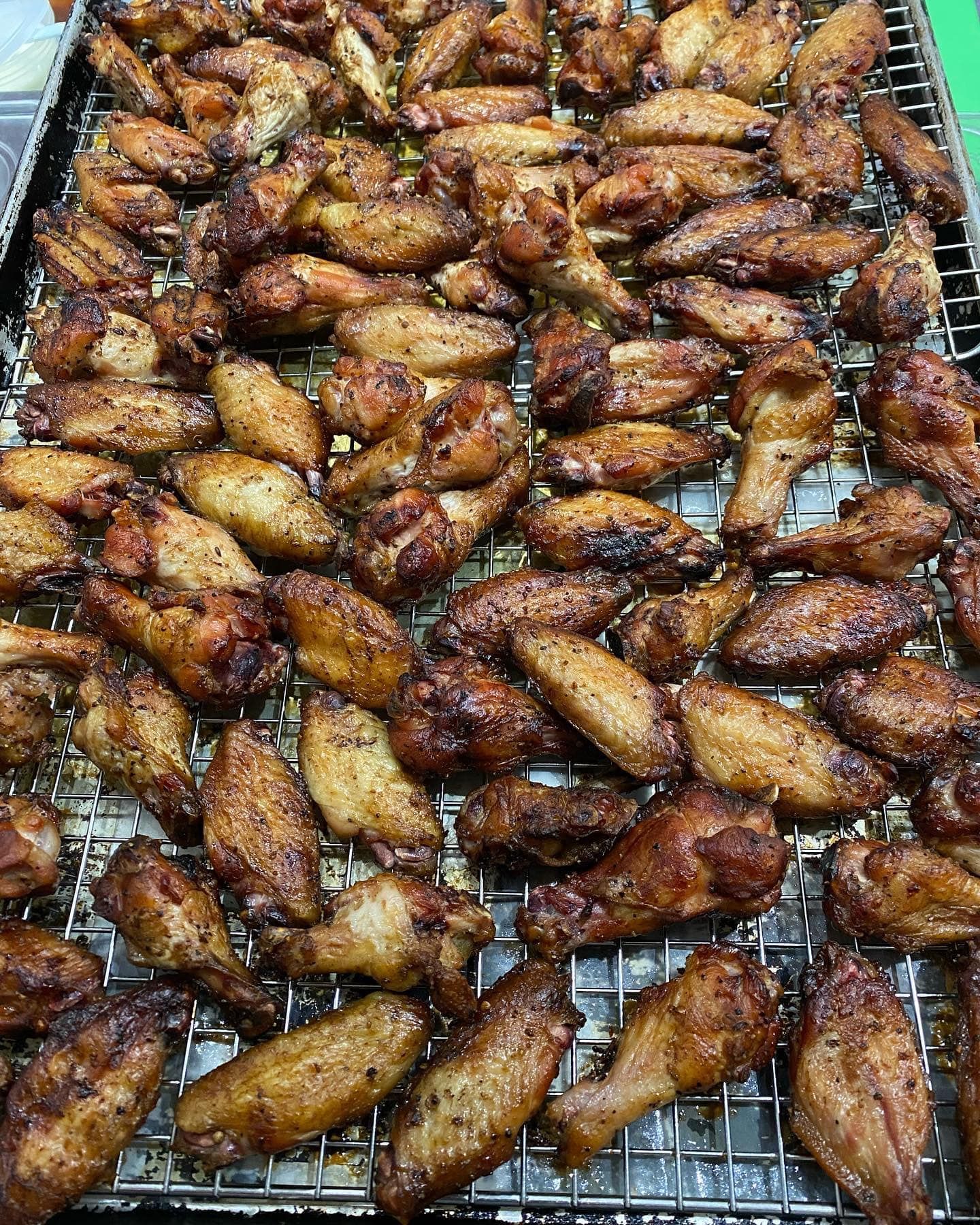 Cooked chicken wings arranged on a metal rack