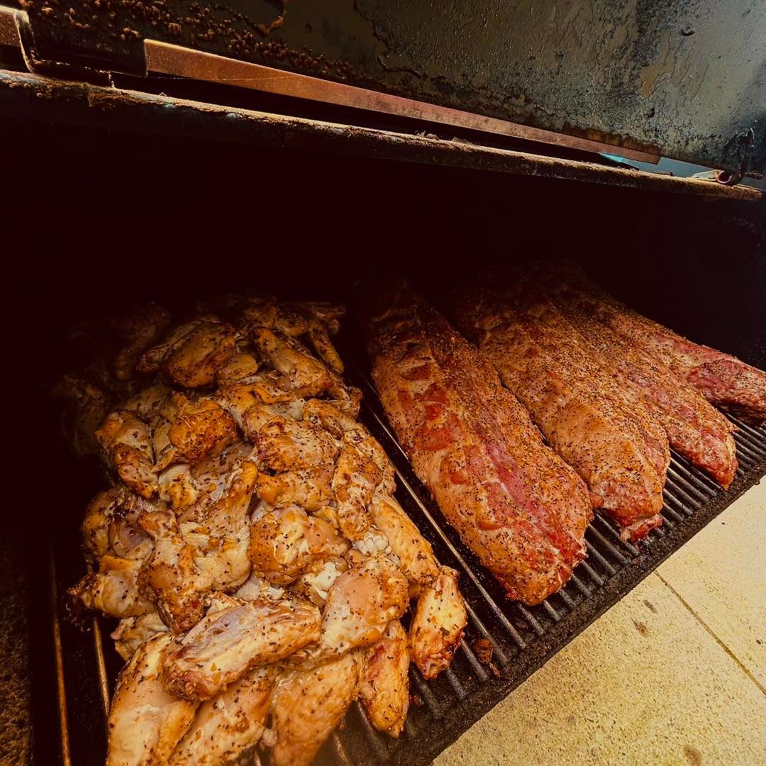 Chicken and seasoned ribs on a smoker grill