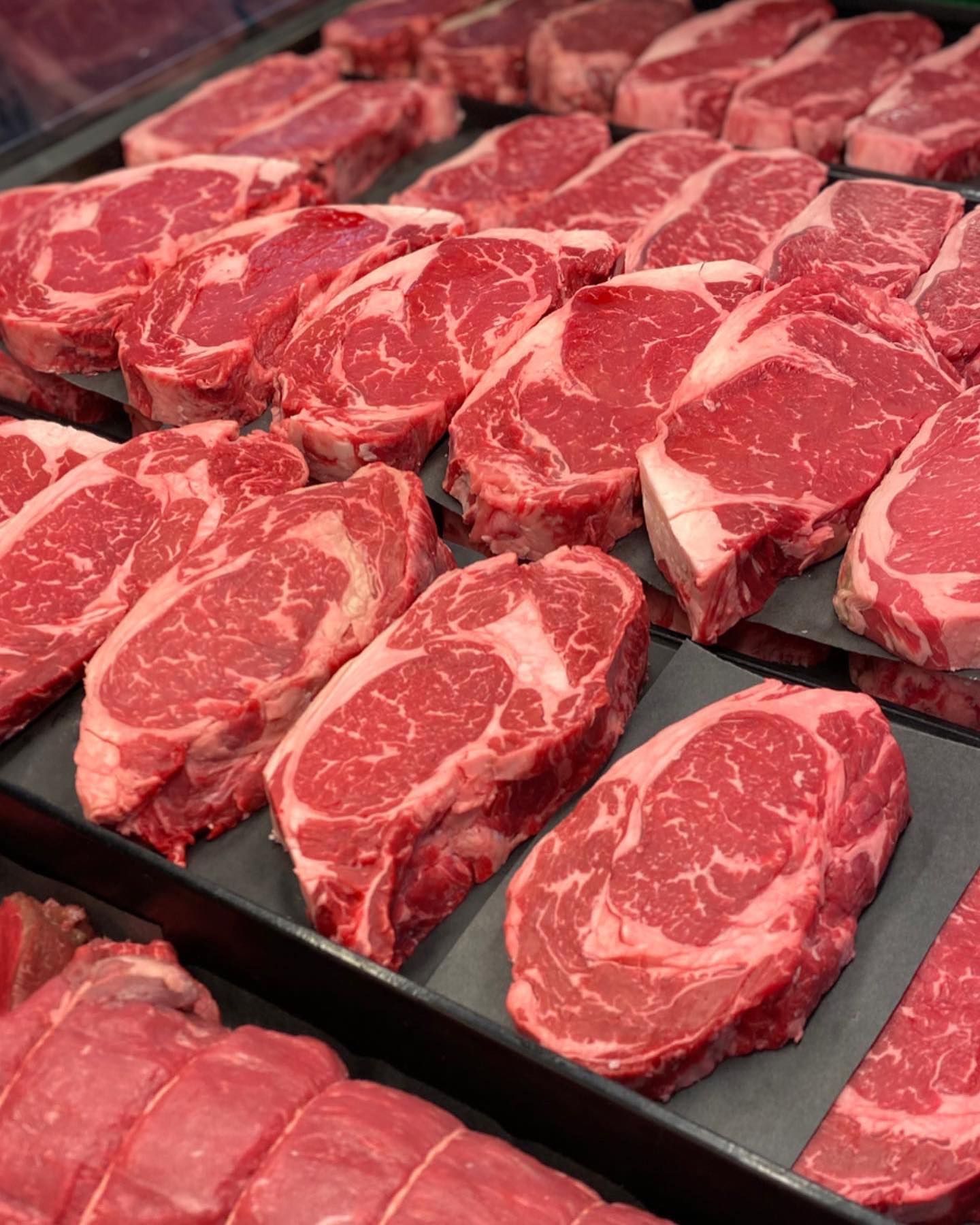 Raw ribeye steaks in a display case