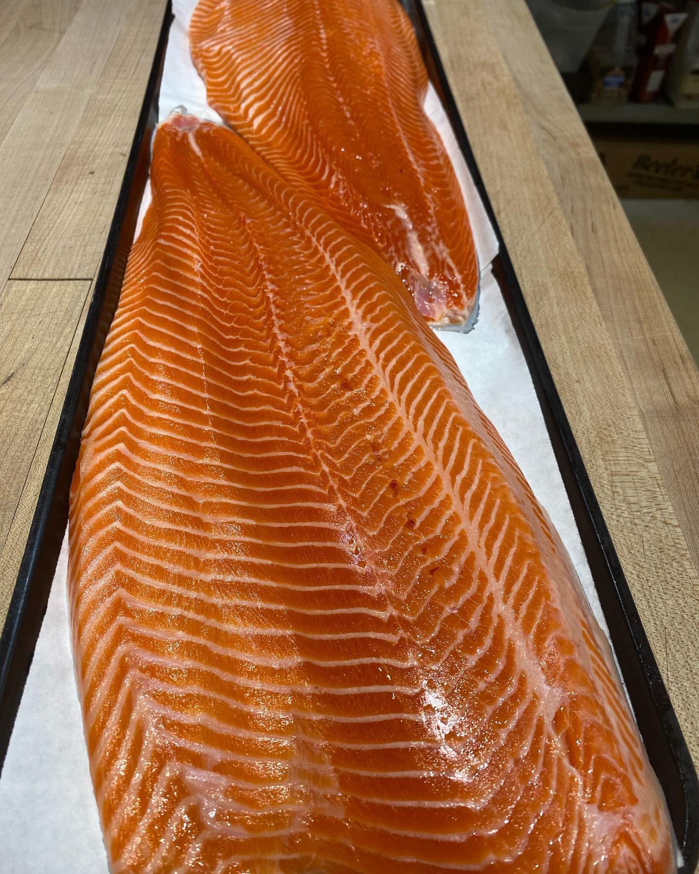 Two salmon fillets on parchment paper