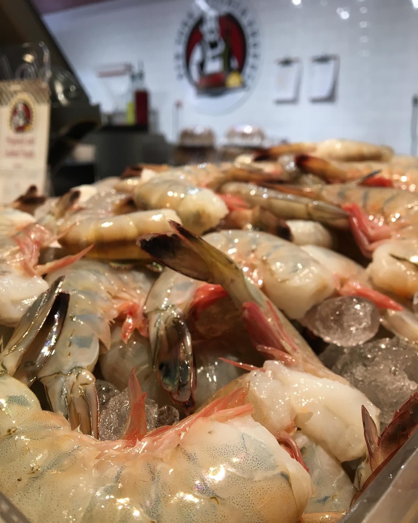 Raw shrimp piled in a display case