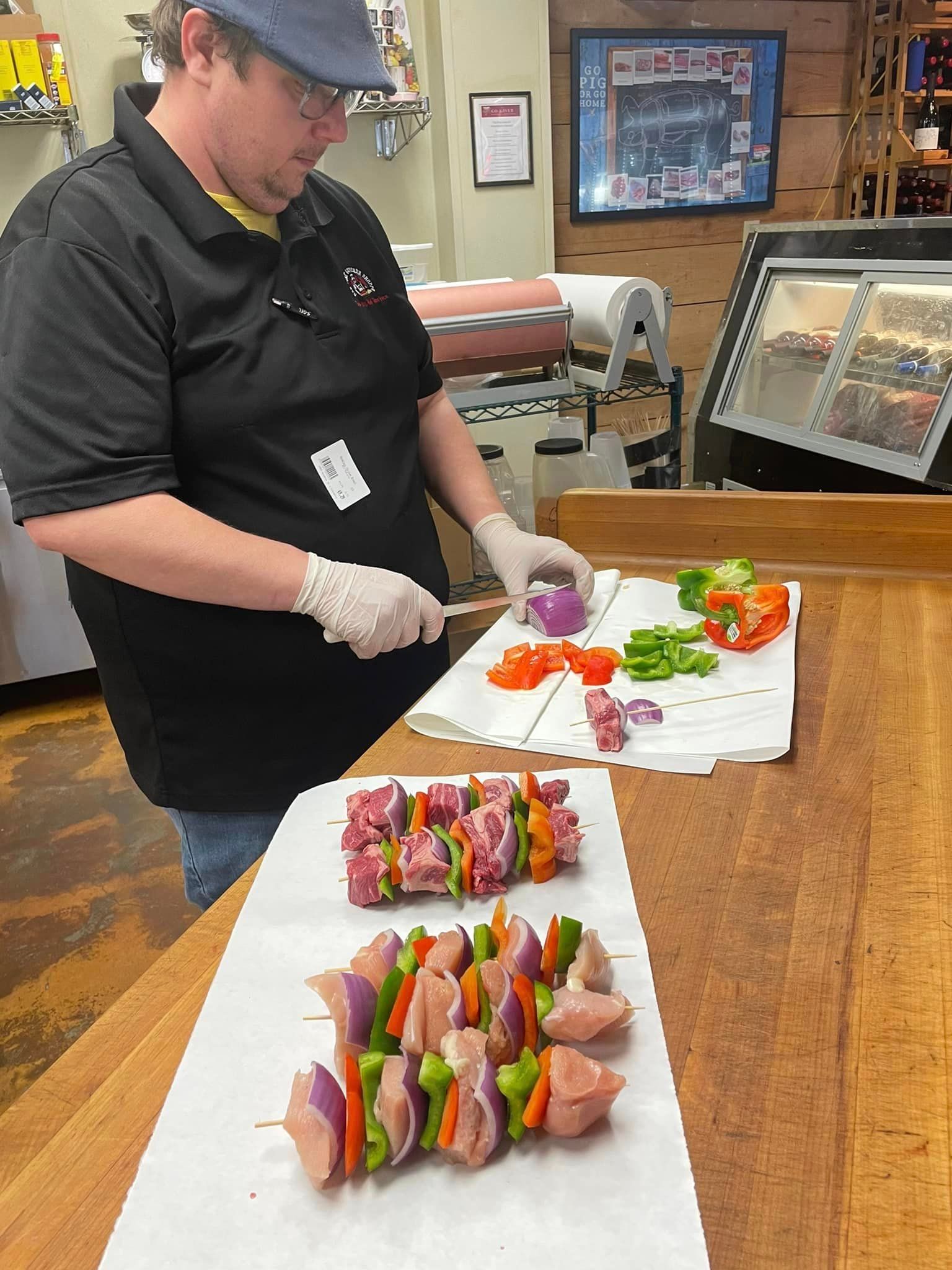 A butcher preparing kebabs