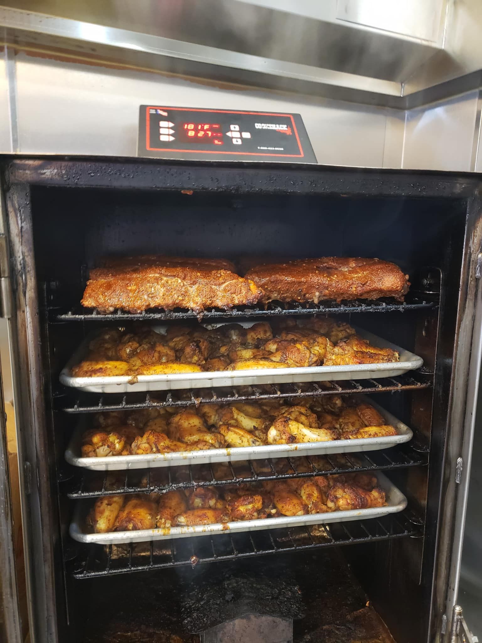 Smoker with trays of food