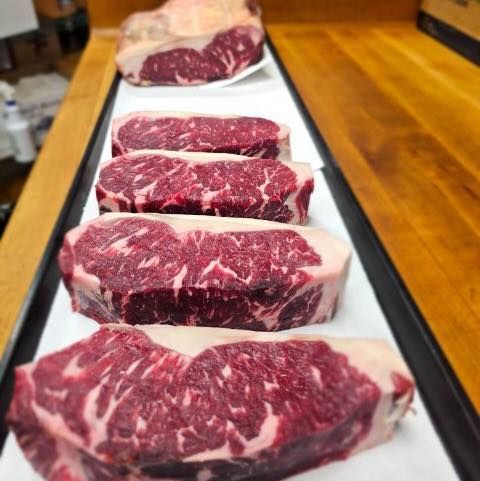 Dry aged NY strips on a platter