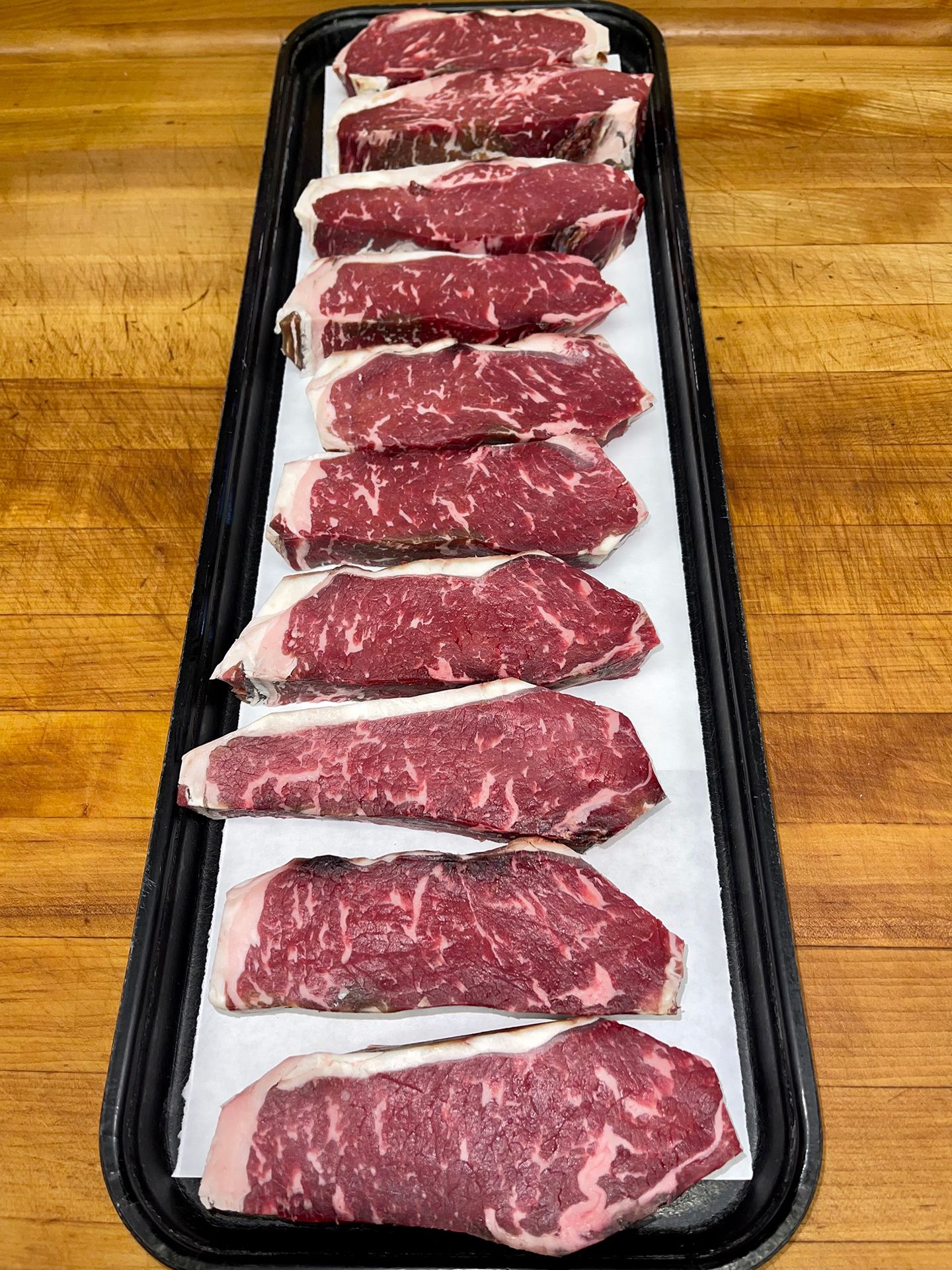 Dry aged strips on a platter