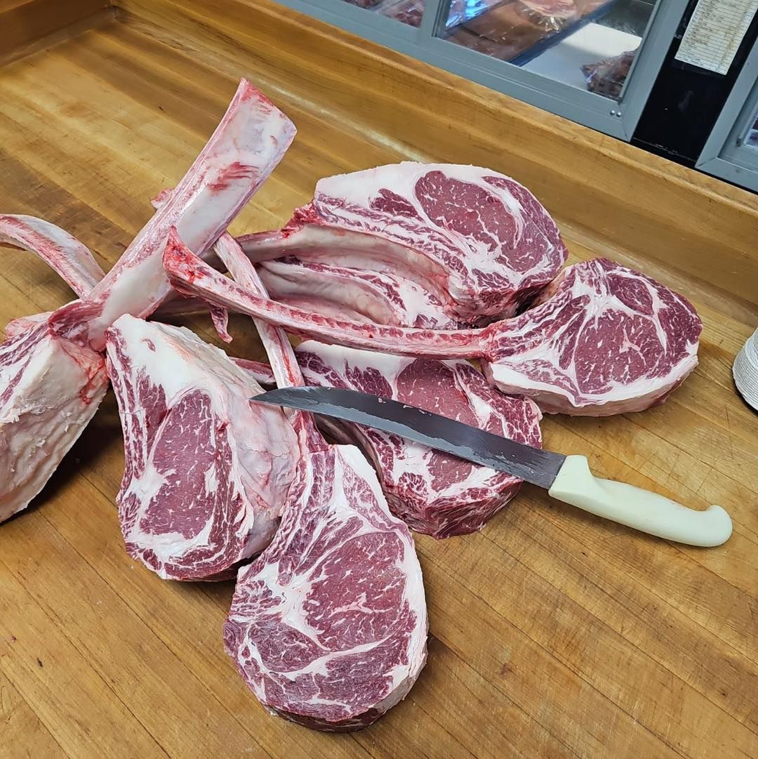 Tomahawks and knife on a wooden butcher block