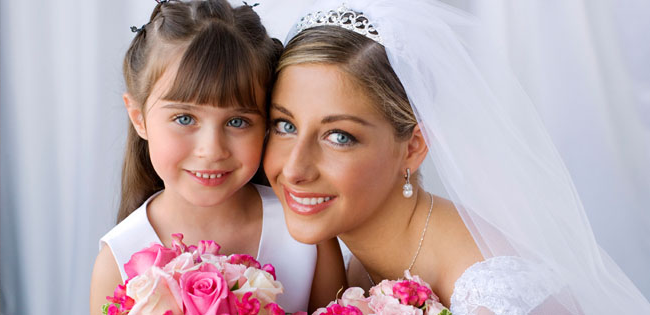bride and flower girl smiling