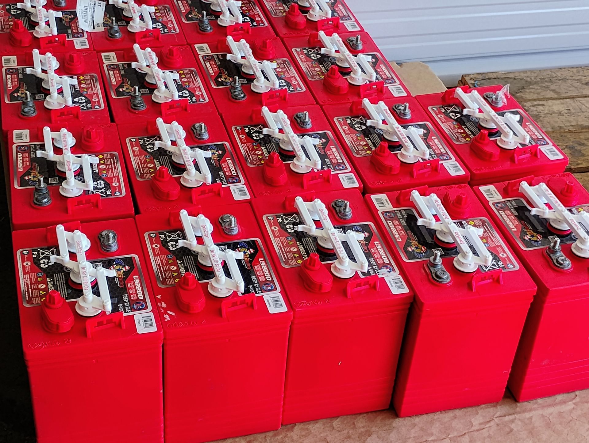 Rows of red batteries with white and black components.