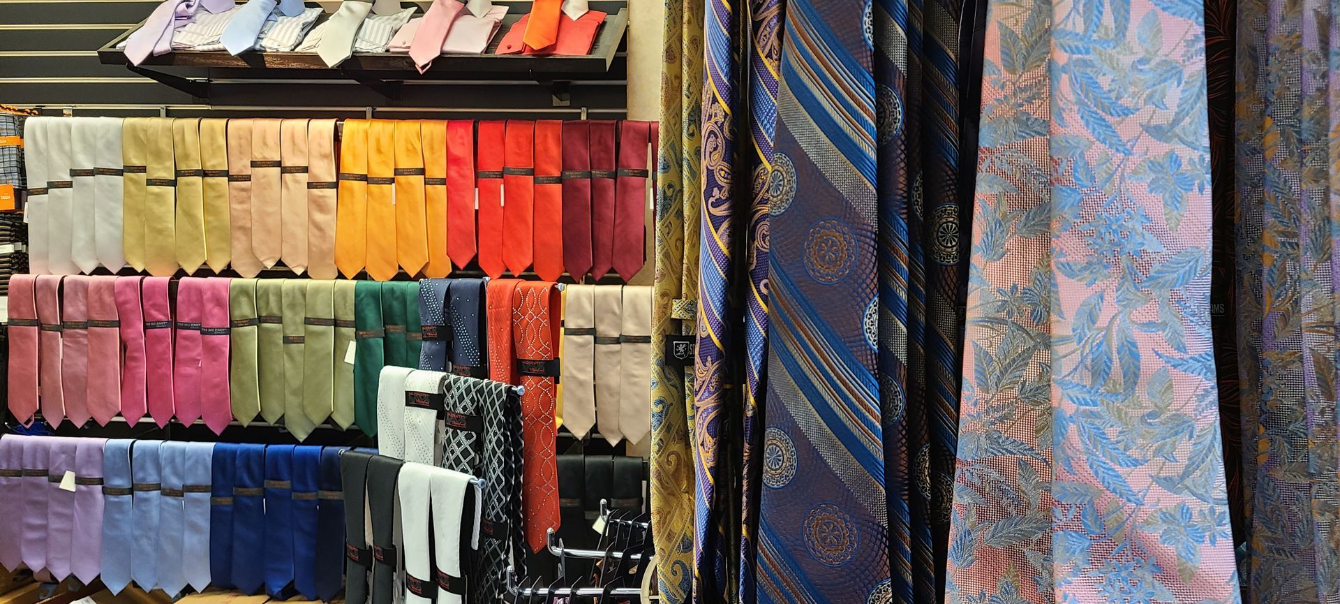 Colorful fabric bolts and hanging textiles displayed in a market stall