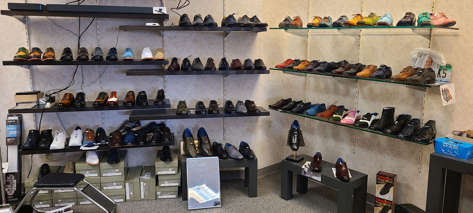 Wall of neatly displayed shoes on shelves in a retail store interior