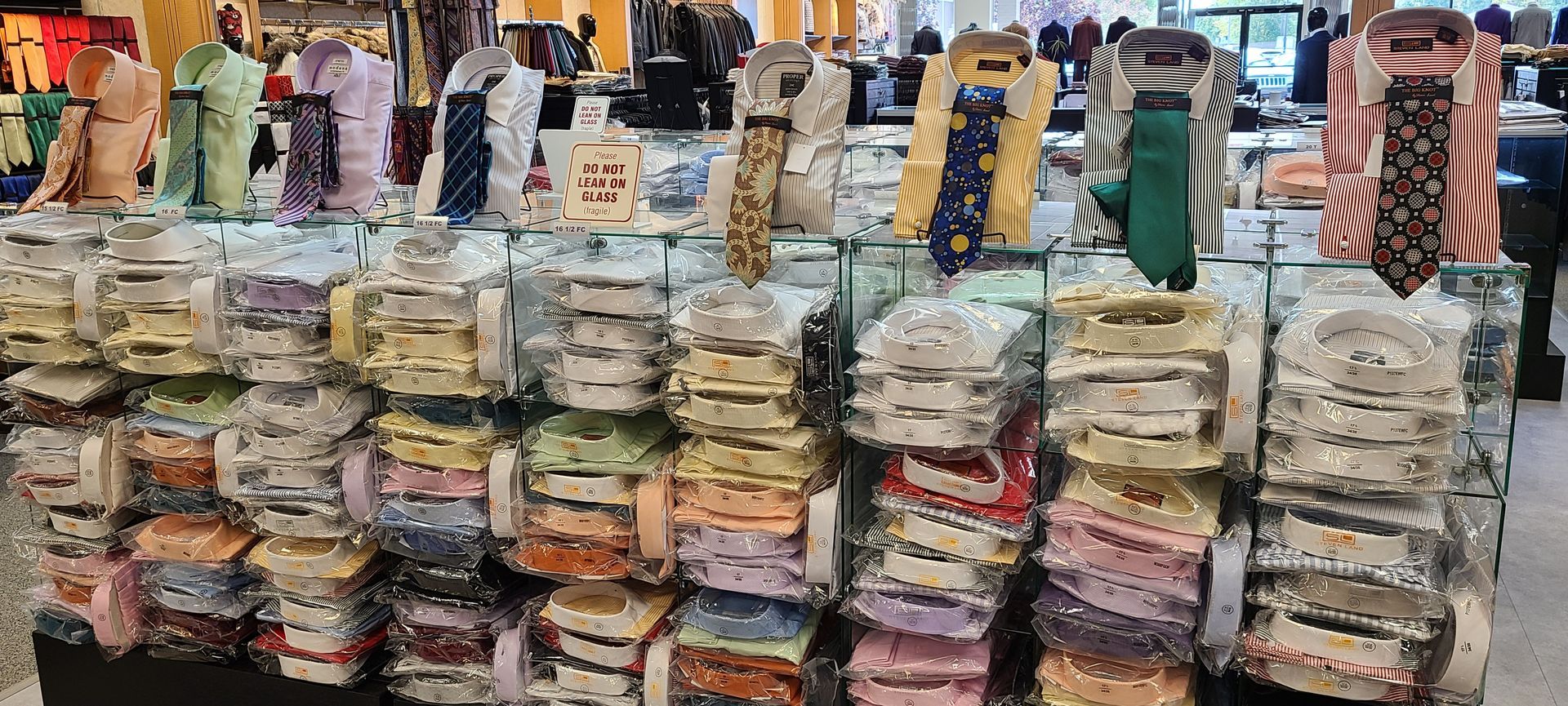 Stacks of packaged goods at an indoor market stall with people browsing in the background