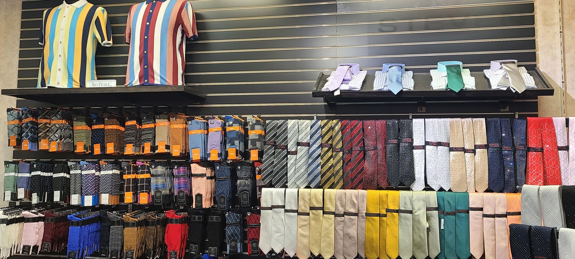 Colorful display of socks, ties, and folded accessories on retail shelves