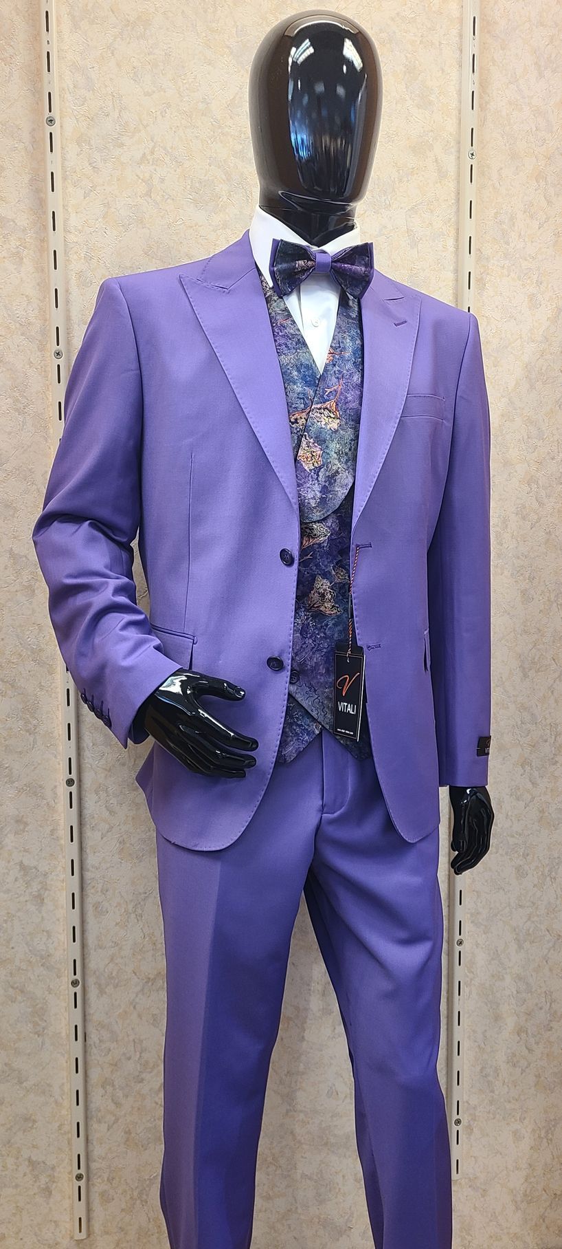 Mannequin wearing a lavender suit with a patterned vest, tie, and pocket square.