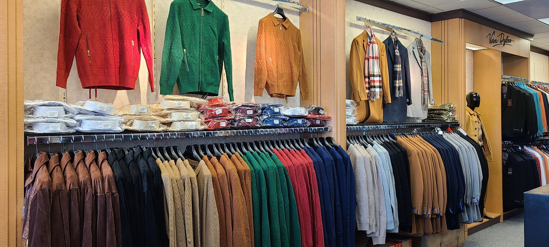 Clothing store display with colorful jackets and rows of neatly hung shirts on racks