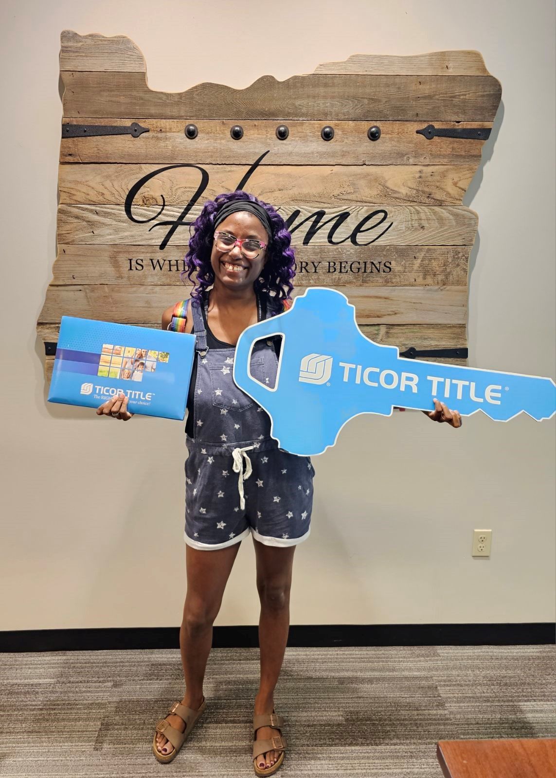 woman holding key sign