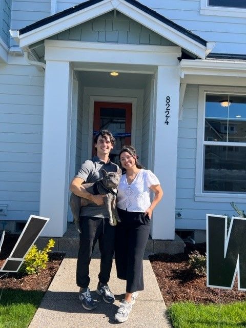 boy holding dog and lady