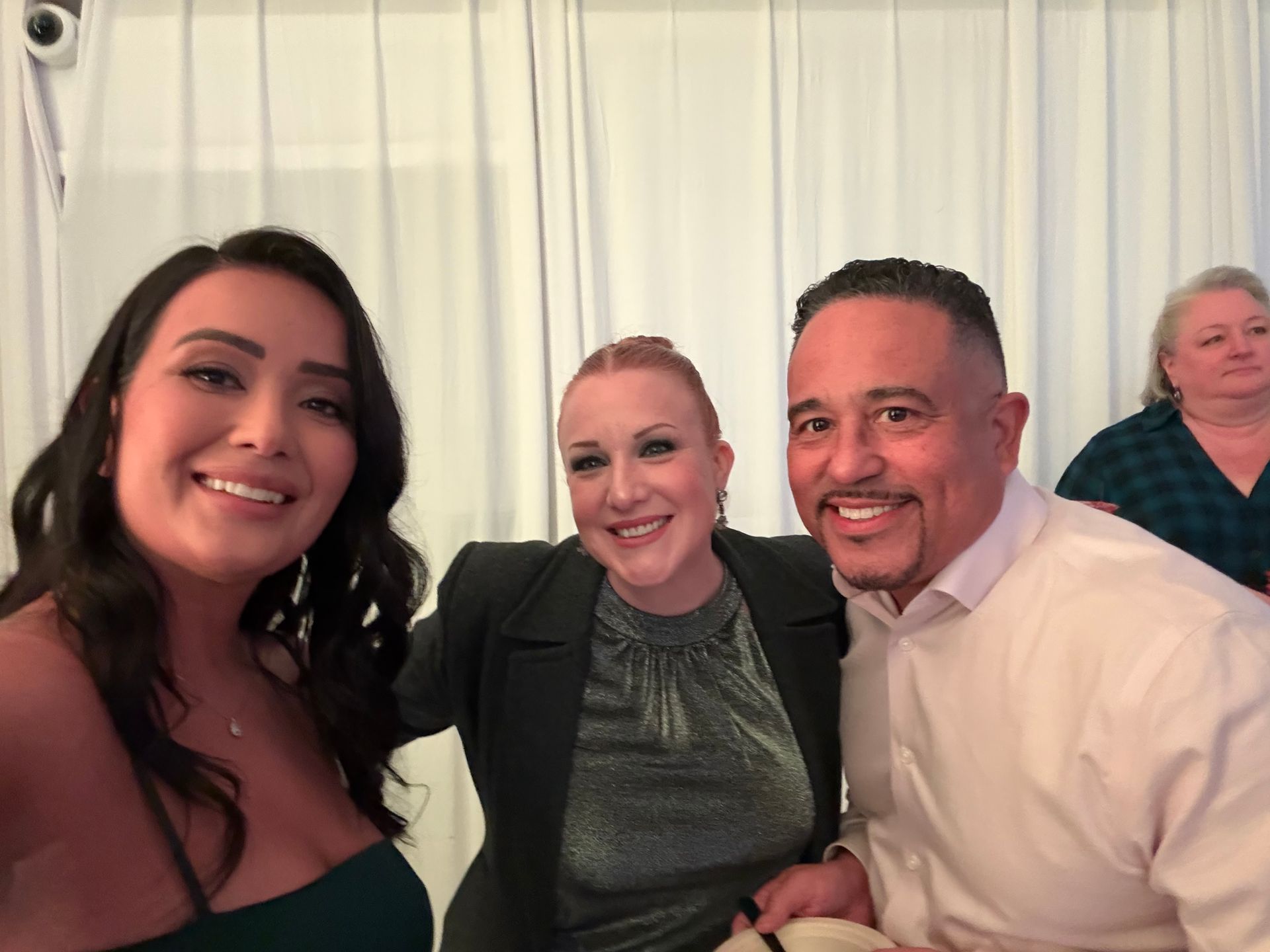 A group of people are posing for a picture together and smiling.