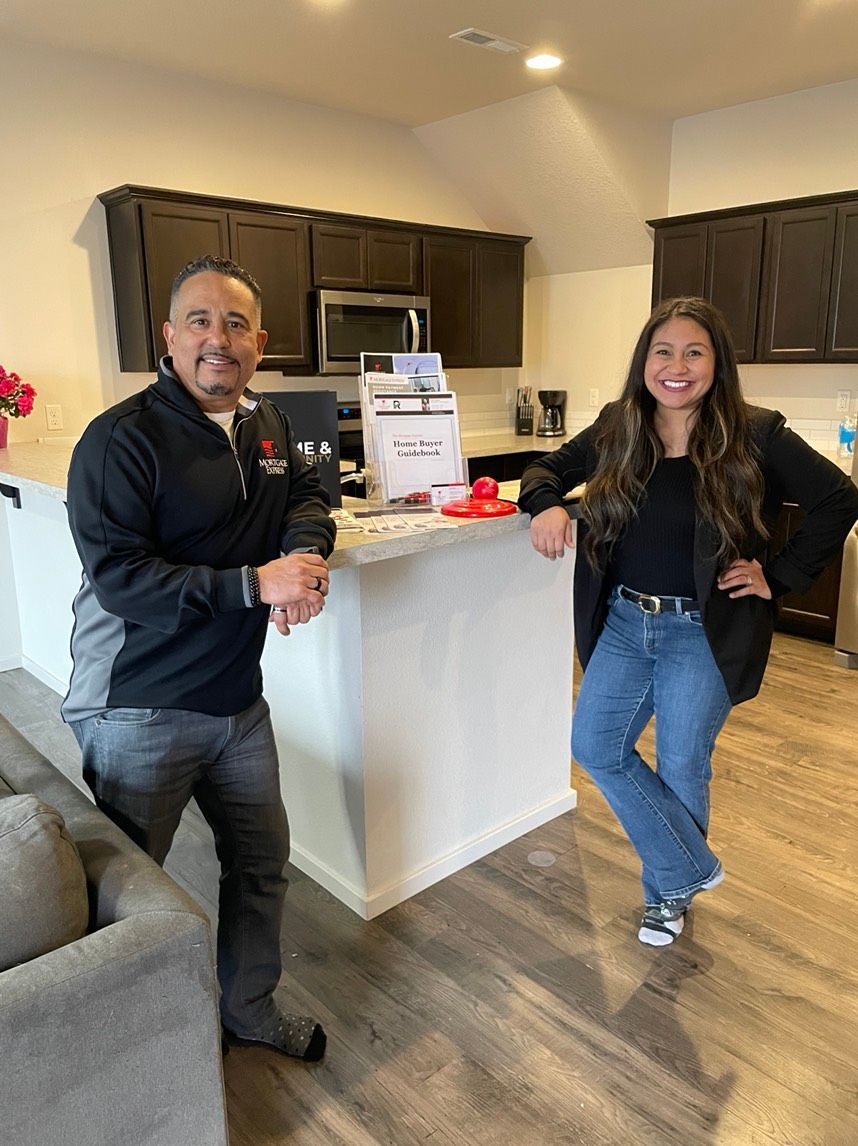 A man and a woman are standing next to each other in a kitchen.