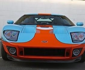 Front view of a blue and orange sports car with racing stripes.
