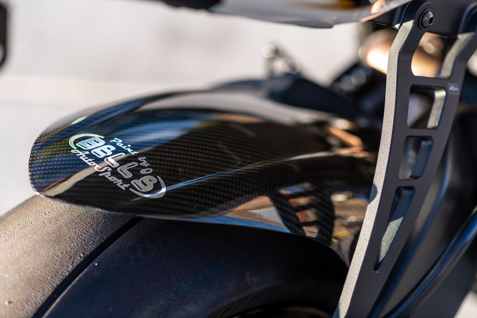 Close-up of a carbon-fiber bicycle saddle on a bike frame.