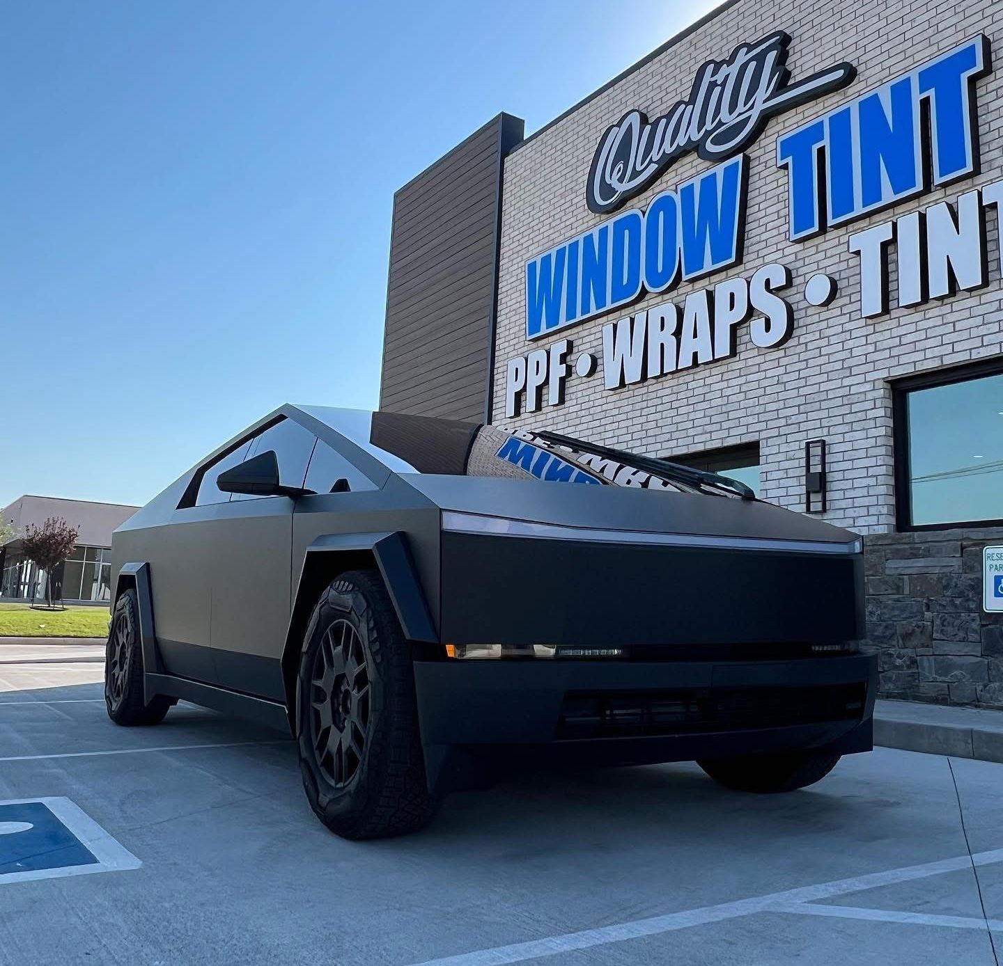 Matte black Tesla Cybertruck in front of 