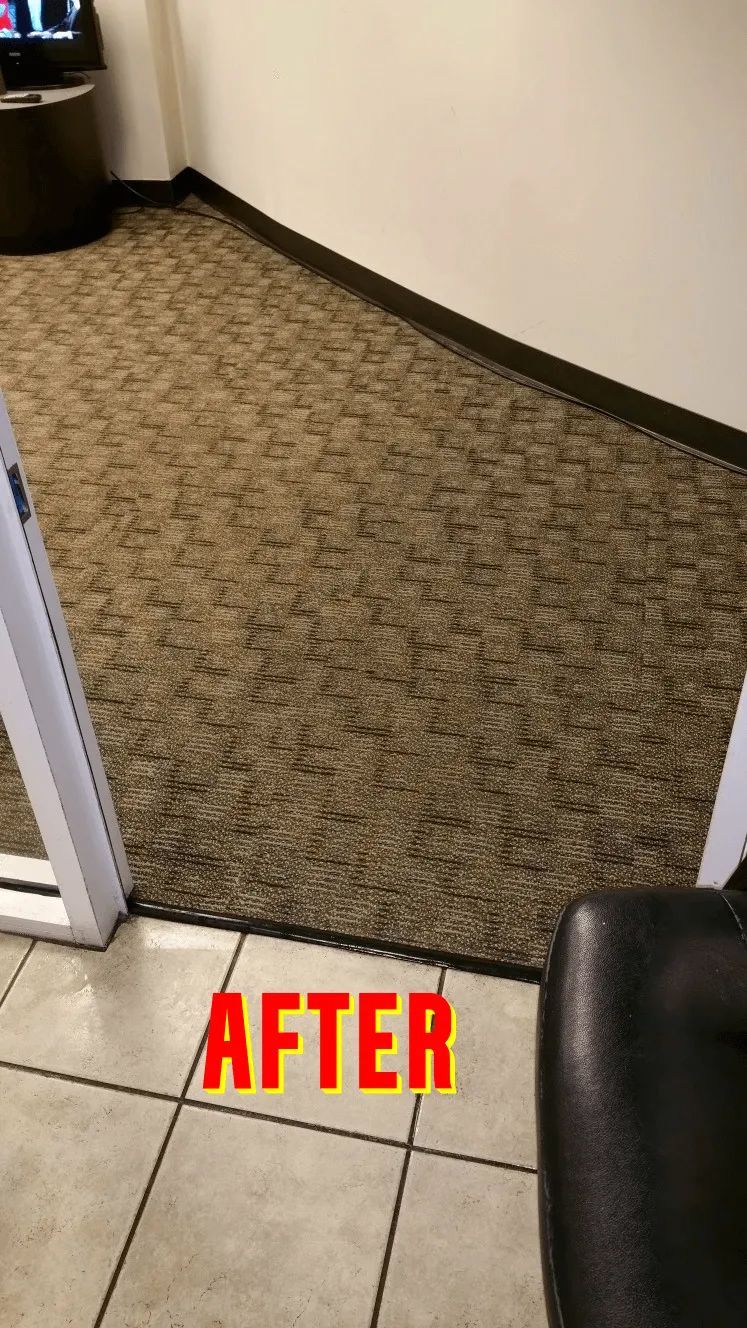 A room with a carpeted floor and a chair in it