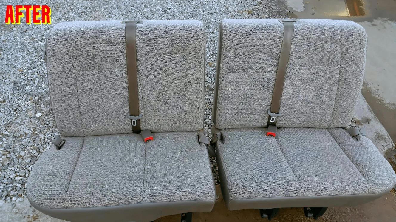 A pair of car seats are sitting next to each other on a gravel road