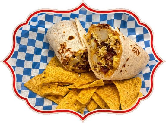 Cut burrito on a red-rimmed plate with tortilla chips and salsa on a blue checkered liner