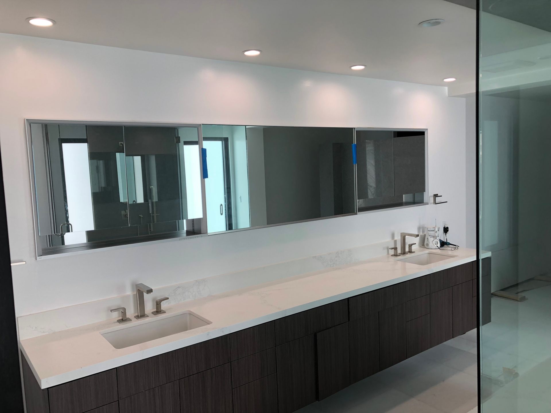 A bathroom with two sinks and a large mirror.