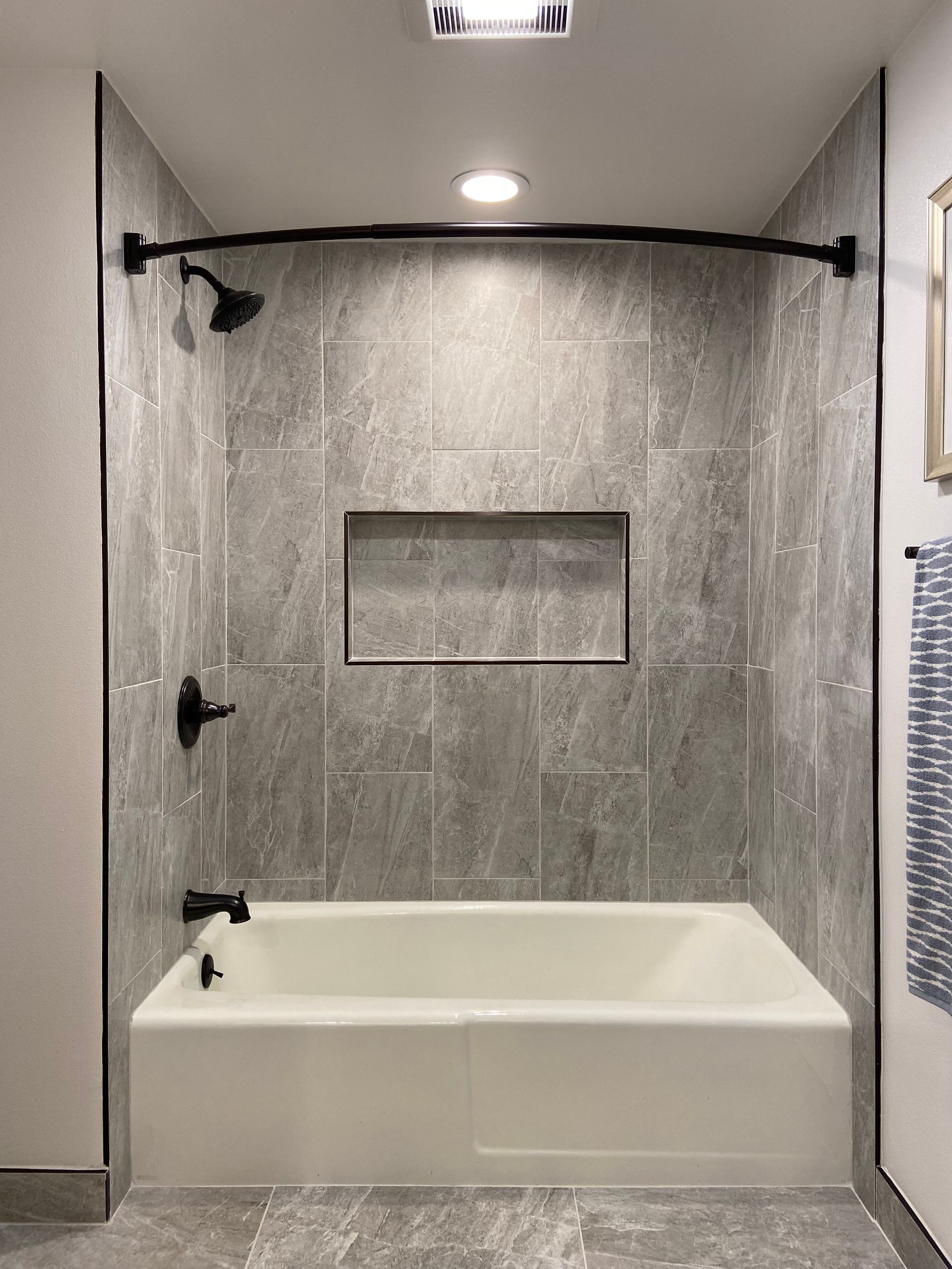 A bathroom with a bathtub and a shower.