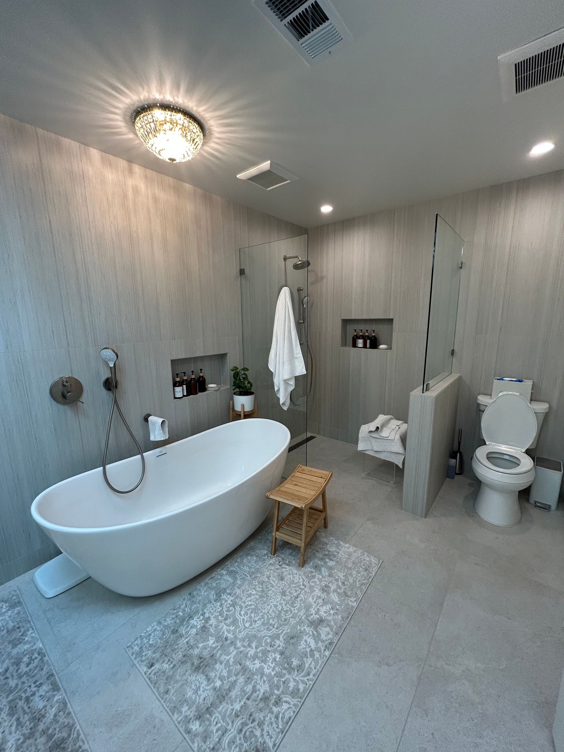 A bathroom with a bathtub, toilet, and shower.