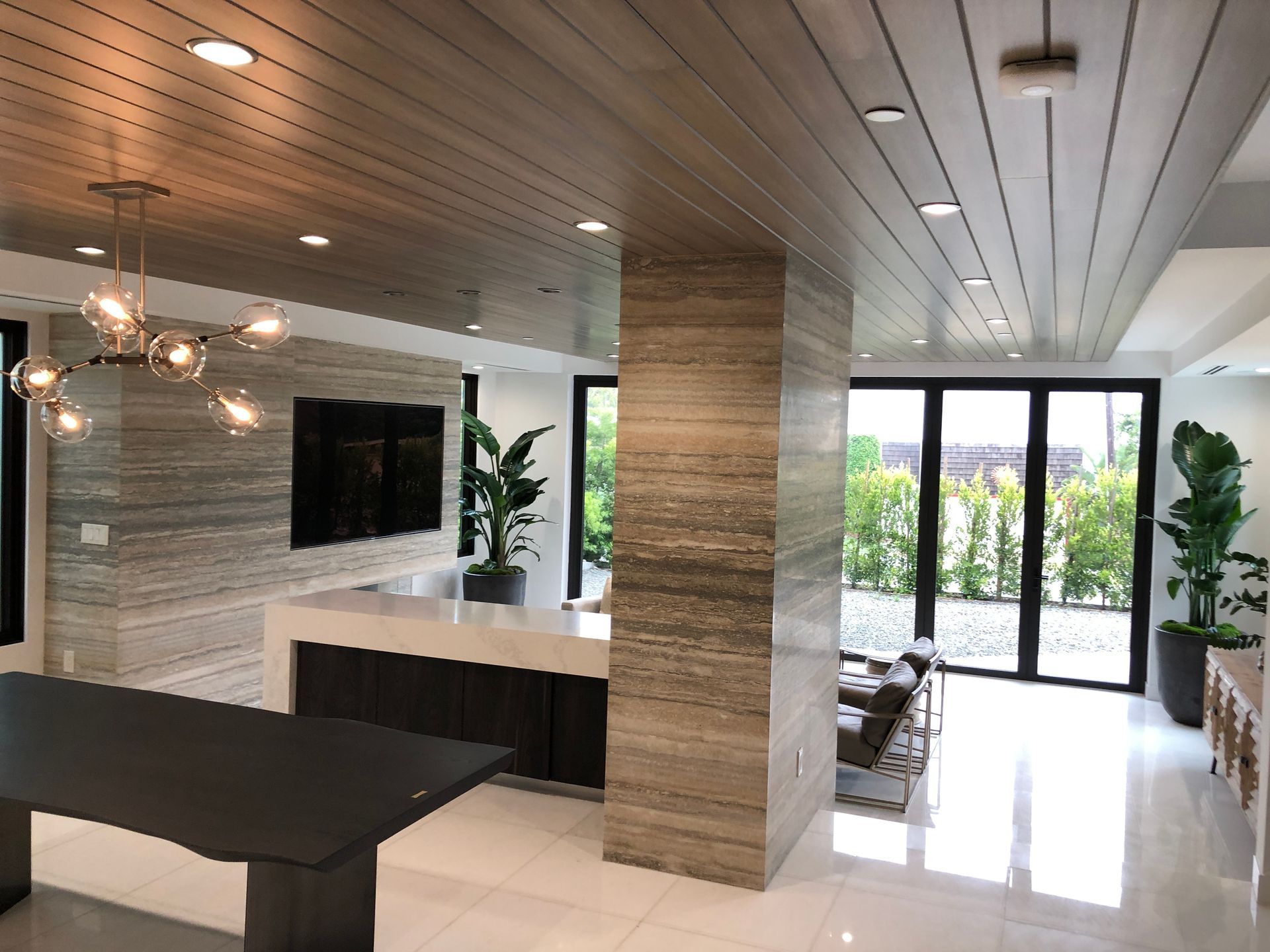 A living room with a table and a television on the wall.