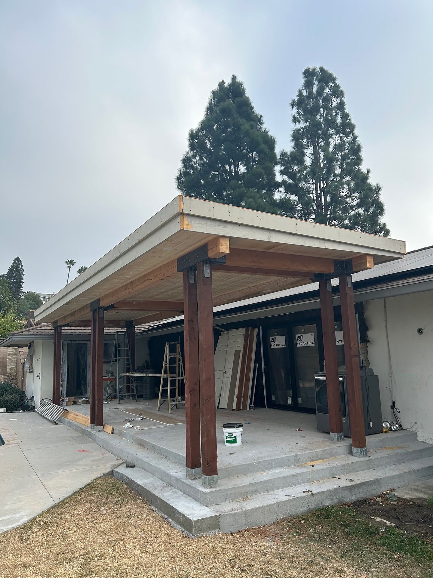 A house is being remodeled with a wooden covered porch