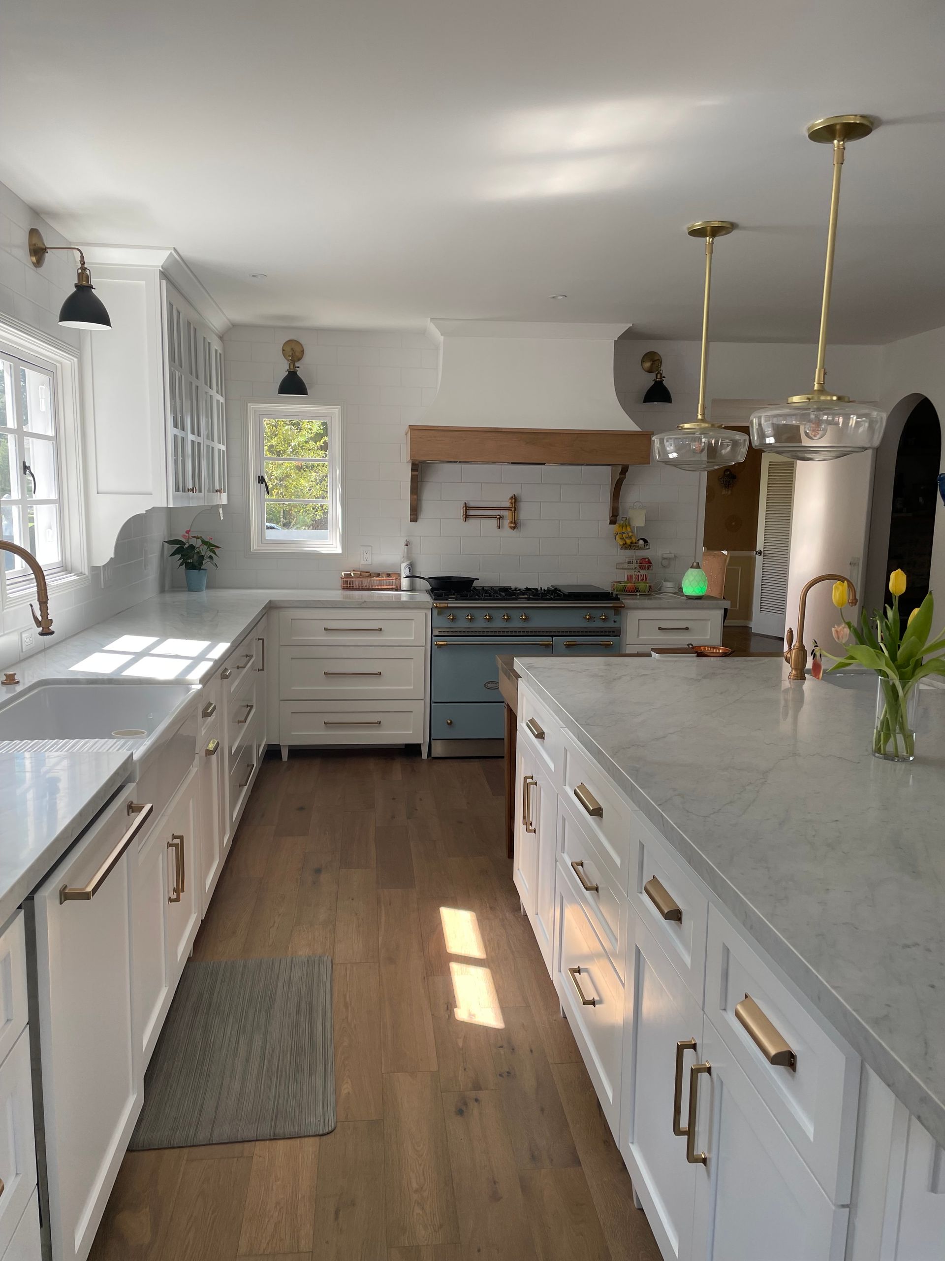A kitchen with white cabinets and a large island in the middle.